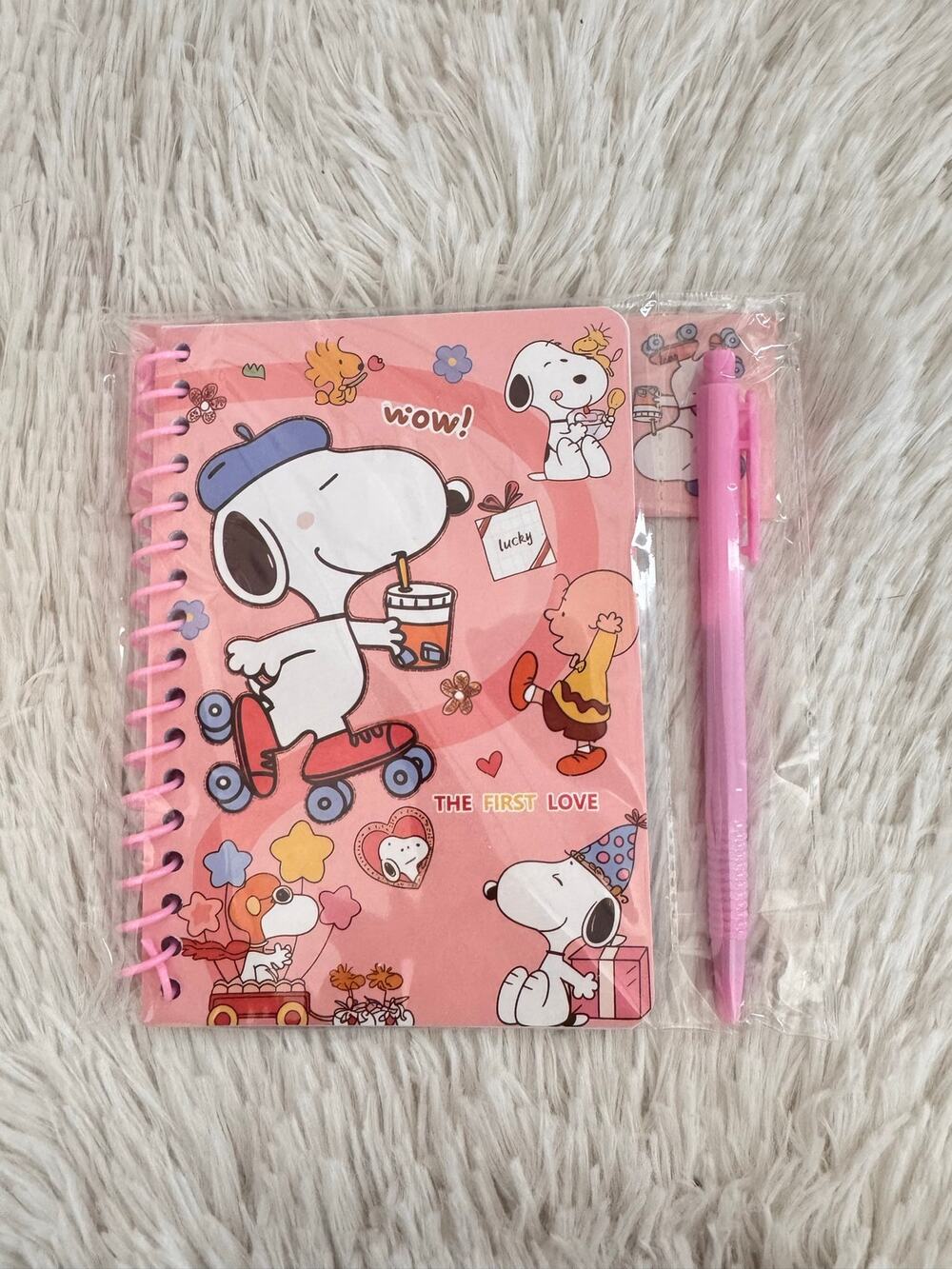 Snoopy spiral pink notebook with pen featuring Snoopy on roller skate size A6 .